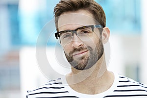 Man with stubble wearing spectacles