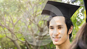 Man student smiles and feel happy in graduation gowns and cap