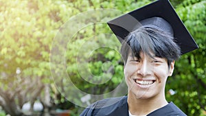 Man student smiles and feel happy in graduation gowns and cap