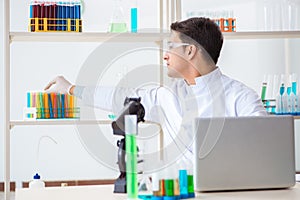 The man student working in chemical lab on experiment