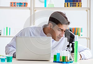 Man student working in chemical lab on experiment