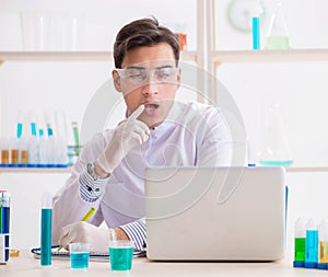 Man student working in chemical lab on experiment