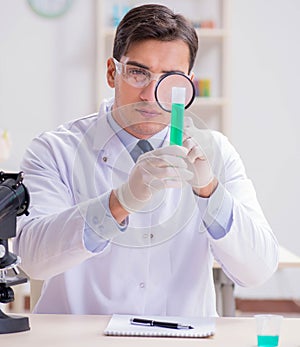 Man student working in chemical lab on experiment