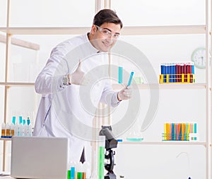 Man student working in chemical lab on experiment