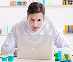 Man student working in chemical lab on experiment