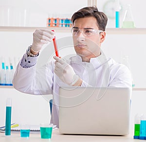 Man student working in chemical lab on experiment
