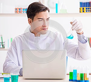 Man student working in chemical lab on experiment
