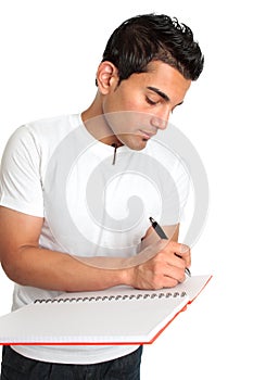 Man or student writes in a notebook photo