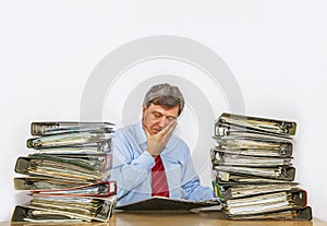 Man studies folder with files at his desk