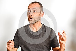 Man in studio overwhelmed, stressed and surprised, model expressions isolating white background
