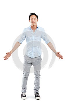 Man, studio portrait and arms outstretch with fashion, sneakers and edgy jeans by white background. Isolated Asian model