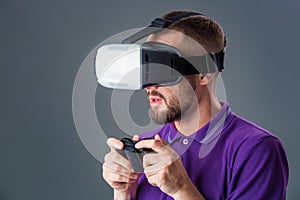 Man in studio wearing virtual reality headset playing game