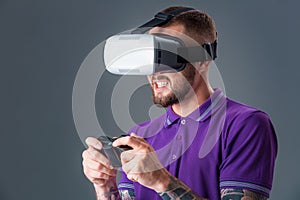 Man in studio wearing virtual reality headset playing game