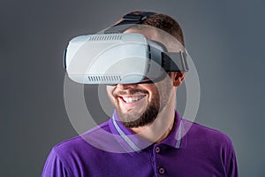 Man in studio wearing virtual reality headset playing game