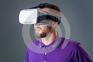 Man in studio wearing virtual reality headset playing game