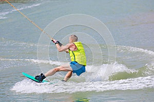 Man study wakeboarding on a blue lake