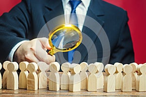 Man studying a crowd of people with a magnifying glass. Market and customers research. Hr search candidates for work, staff