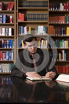 Man Studying At Desk In Library