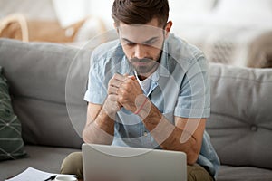 Man studying using computer reading message online