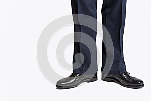 Man in Stylish Black Shiny Male Semi-Brogue Posing in Direct Position Against White.