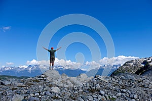 Man in successful pose on mountain top.