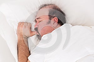 Man sucking his thumb while sleeping