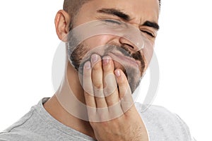 Man suffering from acute toothache on white background, closeup