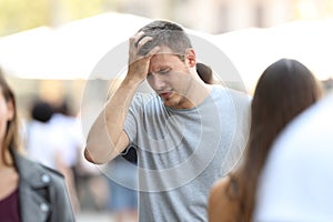 Man suffering head ache on the street