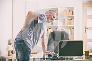 Man suffering from low back pain photo