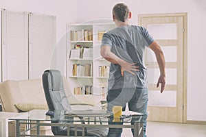 Man suffering from low back pain photo