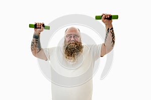 A man suffering from obesity raising his hands up and holding dumbbells. Sportif life concept . Isolated on a white background