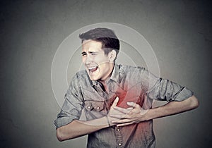 Man suffering from severe sharp heartache, chest pain