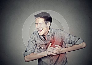 Man suffering from severe sharp heartache, chest pain photo