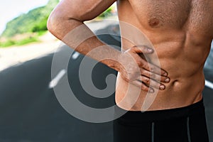 Man Suffering From Stomach Pain After Running Outdoors. Sport Injury