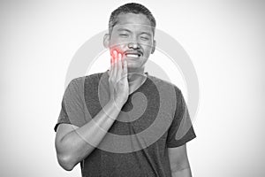 Man suffering from strong toothache.  on gray background. Healthcare and health problem concept