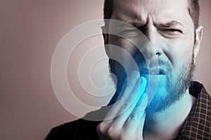 Man suffering from teeth pain