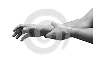 Man suffering from wrist pain, isolated, black and white photo. Causes of pain include sprains in the wrist.
