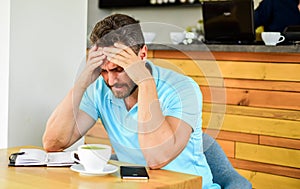 Man suffers headache. Deadline coming search ideas need inspiration. Man disappointed desperate face sit cafe with mug