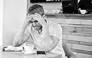 Man suffers headache. Deadline coming search ideas need inspiration. Man disappointed desperate face sit cafe with mug