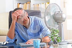 Man suffers from heat in the office or at home