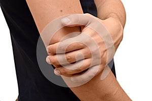 A man suffers from pain in elbow, holds his hand to the elbow, isolated. Healthcare concept, sports injury
