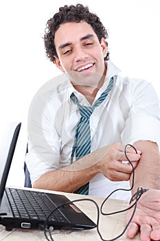 Man in suit addicted to internet put USB cable from laptop comp