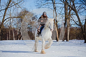 Man in suit of ancient warrior riding big white horse