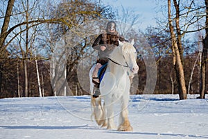 Man in suit of ancient warrior riding big white horse