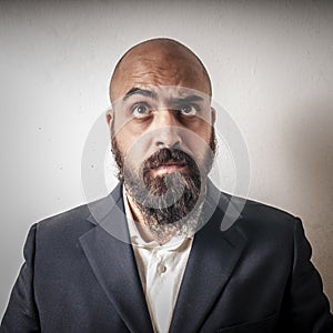 Man with a suit and beard and strange expressions