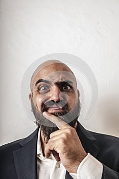 Man with a suit and beard and strange expressions