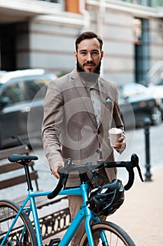 A man in a suit with a bicycle makes his way to work. Ecological urban transport. Modern active lifestyle