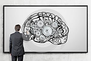 Man in suit with brain and gears sketches