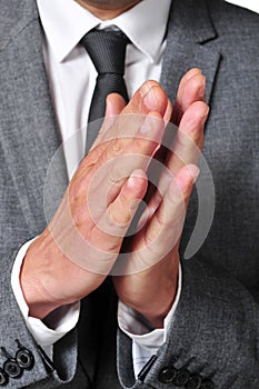 Man in suit clapping his hands