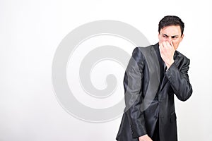 Man in suit disgusted by bad smell